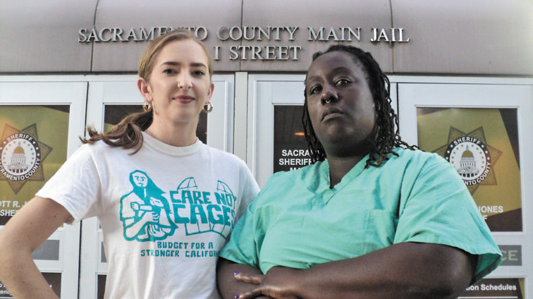 Two women stand in front of Sacramento County Jail