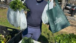 Mandip Kaur in a park with food from a farmer's market