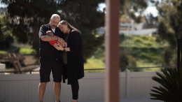 Tony and Sara Iagmin hold a three-month-old baby they are fostering