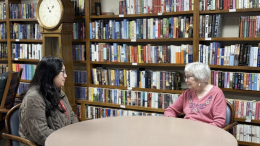 ACC PEARLS care coordinator Macy Quan sits with PEARLS participant Susan Kane at a table within a library in 2024. (Photo courtesy of ACC Senior Services)