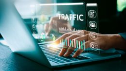 website image superimposed over computer keyboard with hands typing