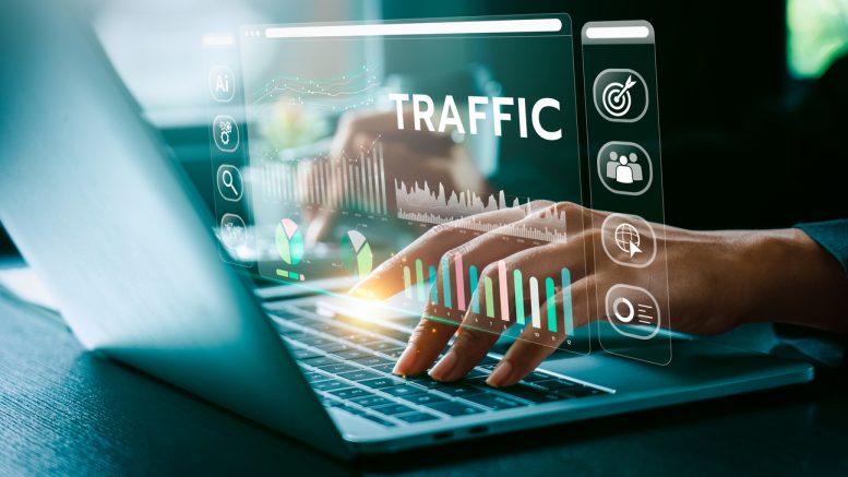 website image superimposed over computer keyboard with hands typing